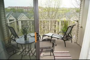 a patio with a table and chairs on a balcony at Branson Krehbiel Condo 2Bd 2Bath in Branson