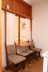 a room with a table and two chairs and a window at Studio Trstenik 4566b in Trstenik