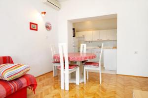 a kitchen and dining room with a table and chairs at Apartments by the sea Kneza, Korcula - 4371 in Pupnat +14 photos