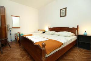 a bedroom with two beds and a phone at Seaside holiday house Lumbarda, Korcula - 4422 in Lumbarda