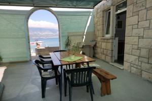 a table and chairs in a room with a window at Seaside holiday house Lumbarda, Korcula - 4422 in Lumbarda