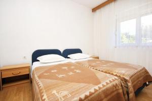 a bedroom with a bed and a window at Apartments by the sea Cove Vrbovica bay - Vrbovica (Korcula) - 4452 in Korčula