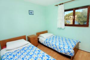 Postel nebo postele na pokoji v ubytování Seaside holiday house Cove Gradina, Korcula - 4457