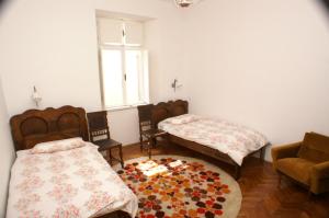 a room with two beds and a rug at Apartments by the sea Korcula - 4450 in Korčula