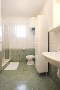 a bathroom with a toilet and a sink at Apartment Kneza 4342a in Račišće