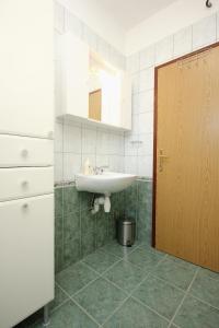 a bathroom with a sink and a mirror at Apartment Kneza 4342a in Račišće