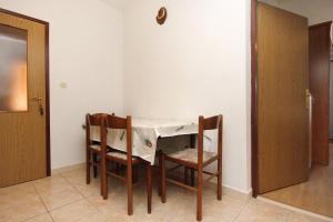 uma pequena mesa e cadeiras num quarto em Apartment Kneza 4342a em Racisce