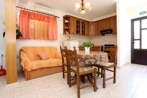 a kitchen and dining room with a table and a couch at Apartments with parking space Lumbarda, Korcula - 4352 in Lumbarda