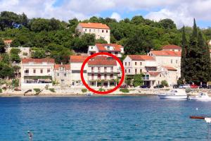 a building in the middle of a body of water at Studio Racisce 4341c in Račišće