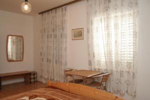 a dining room with a table and a window at Double Room Korcula 4356c in Korčula