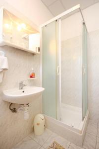 uma casa de banho com um lavatório e um chuveiro em Rooms with a parking space Lumbarda, Korcula - 4436 em Lumbarda
