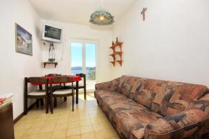 a living room with a couch and a table at Apartments by the sea Lumbarda, Korcula - 4440 in Lumbarda