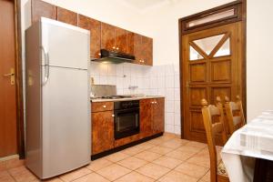 a kitchen with a refrigerator and a stove at Apartments with parking space Zavalatica, Korcula - 4453 in Zavalatica