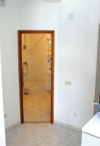 a bathroom with a shower and a toilet and a tub at Apartments by the sea Luka Dubrava, Peljesac - 4568 in Janjina