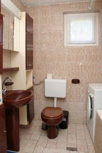 a bathroom with a toilet and a sink at Apartments by the sea Sreser, Peljesac - 4557 in Janjina