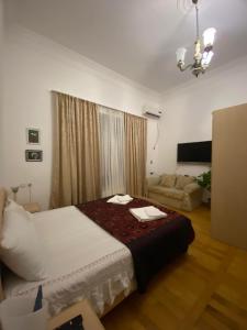 a bedroom with a bed and a living room at House 1899 in Kutaisi