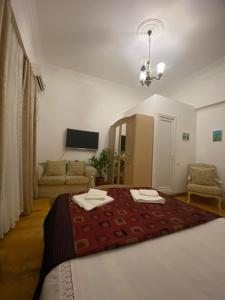 a bedroom with a bed with two towels on it at House 1899 in Kutaisi