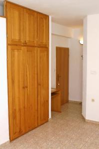 an empty room with a closet and a wooden door at Studio Zuljana 4576b in Žuljana