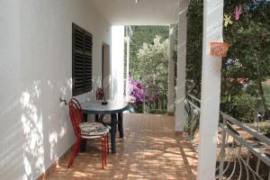 a porch with a table and chairs on a patio at Apartments by the sea Cove Zarace - Gdinj, Hvar - 4598 in Gdinj