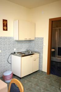 a kitchen with a sink and a counter top at Family friendly seaside apartments Cove Jagodna - Brusje, Hvar - 4606 in Brusje