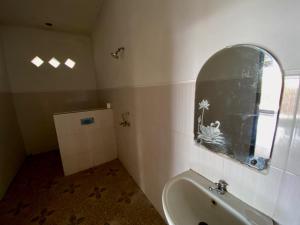 ein Badezimmer mit einem Waschbecken, einem Fenster und einer Badewanne in der Unterkunft sriganesh in Ambat