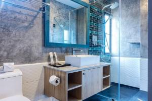 a bathroom with a sink and a shower at Coco Retreat Phuket Resort and Spa - SHA Plus in Chalong 