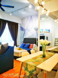 a living room with a couch and a table at HomeZz Imperium Residence Kuantan Studio Seaview in Kuantan