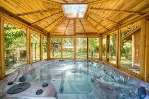 a hot tub in a wooden house with a ceiling at Large Tampa Home*Sleeps 16*Near Busch Gardens &USF in Tampa