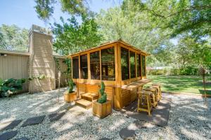 a wooden cabin with a table and chairs in a yard at Large Tampa Home*Sleeps 16*Near Busch Gardens &USF in Tampa