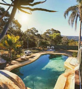 a swimming pool with a view of the ocean at Central Coast Getaway 4B Family Holiday Home in Umina