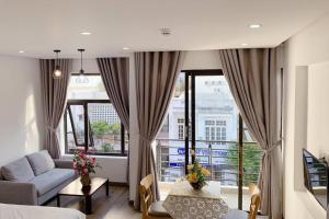 a living room with a couch and a large window at POOL Seaview 3A - Deluxe Apartment BALCONY in Da Nang