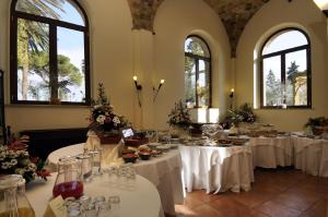 ein Zimmer mit Tischen und weißen Tischdecken in der Unterkunft Hotel Villa Fiorita in Giulianova