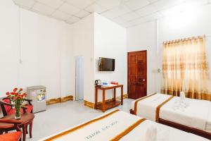Postel nebo postele na pokoji v ubytování Ngoc Qui Bungalow
