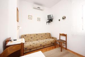 a living room with a couch and a chair at Apartments by the sea Orebic, Peljesac - 4525 in Orebić