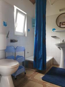 a bathroom with a toilet and a sink and a tub at Apartments by the sea Dingac - Potocine, Peljesac - 4533 in Potomje