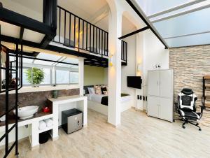 a loft conversion with a bedroom and a bed at La Vista EcoHouse in Macanal