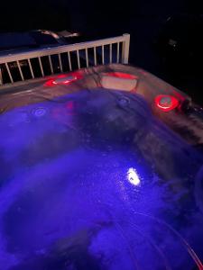 a hot tub with purple water and lights in it at Seaside Beach Front House on the Promenade in Seaside