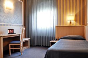 Postel nebo postele na pokoji v ubytování Hotel Garda