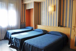 Postel nebo postele na pokoji v ubytování Hotel Garda
