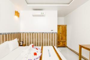Postel nebo postele na pokoji v ubytování Ngoc Qui Bungalow