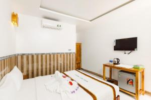 Postel nebo postele na pokoji v ubytování Ngoc Qui Bungalow