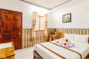 Postel nebo postele na pokoji v ubytování Ngoc Qui Bungalow