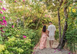 a man and a woman walking down a path at Sara Resort in Koh Rong Sanloem