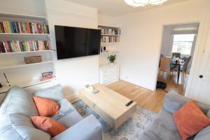 a living room with a couch and a coffee table at Alma House by 360Stays - Private Garden, Free Parking, Close to Oxford City Centre with Parking in Oxford