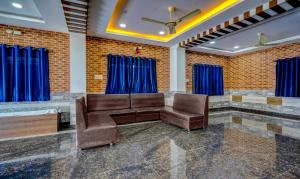 a waiting room with a couch and chairs at Itsy By Treebo - Galaxy Park in Shamshabad