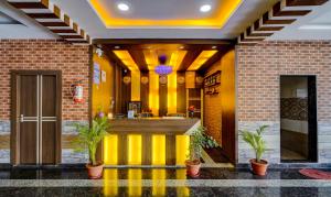 a lobby with a bar in a building at Itsy By Treebo - Galaxy Park in Shamshabad