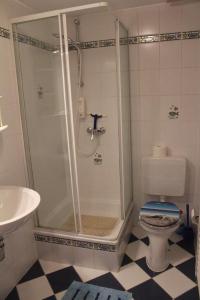 a bathroom with a shower and a toilet at Mira in Timmendorfer Strand