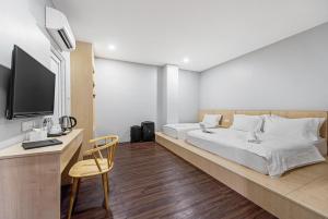 Postel nebo postele na pokoji v ubytování Hako Hotel Taman U