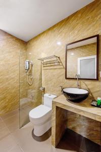 a bathroom with a sink and a toilet and a mirror at Hako Hotel Taman U in Johor Bahru