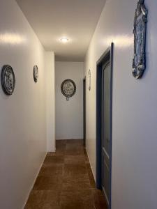 a hallway with a door and plates on the walls at The Royalty Inn ApartmentHotel #1 in Guayaquil